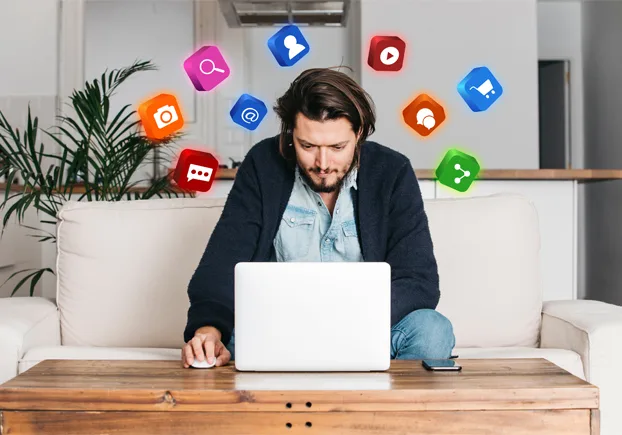 man sitting on couch working in laptop 1.webp