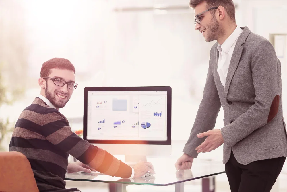 Two businessmen analyzing stats financial data in office